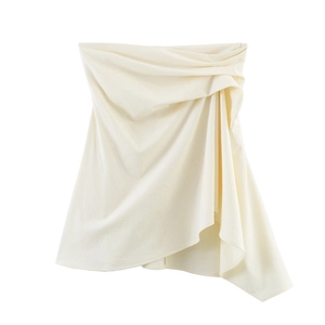Detail view of cream backless strapless top with asymmetric pleats and draped fabric texture