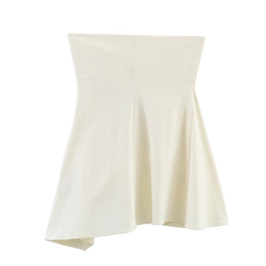 Detail shot of the cream white strapless top showing subtle knit texture and A-line cut