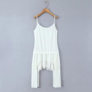 Detailed view of the layered lace trim on the hem of this white summer slip dress