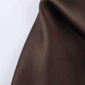 Close-up of deep brown satin fabric showing smooth texture and soft silk luster