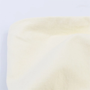 Close-up of pleated backless top fabric showing soft cream texture and fine stitching details