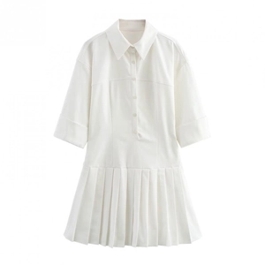 Close-up of a white shirt dress featuring a classic collar and crisp pleated skirt detail