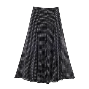 Detailed view of black high-waisted A-line skirt with white polka dot pattern