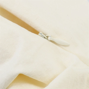 Close-up of invisible zipper detail on cream-colored fabric with soft brushed texture