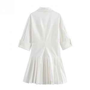 Detailed view of white pleated shirt dress with cuffed sleeves and a lapel collar