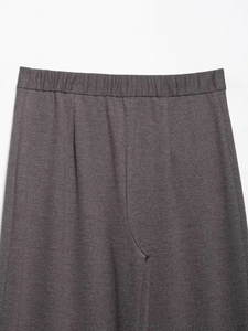 Detailed close-up of dark grey joggers featuring elastic waistband and knit texture