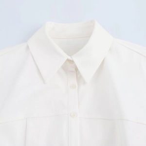 Close-up of the classic pointed collar and matching white buttons on a cotton shirt