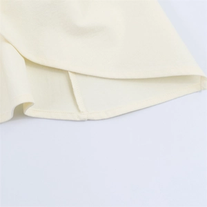 Detailed close-up showing the neat hem stitch and high-quality off-white plain weave fabric