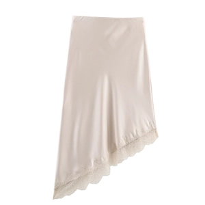 Detailed view of champagne satin skirt featuring asymmetrical hem with eyelash lace trim