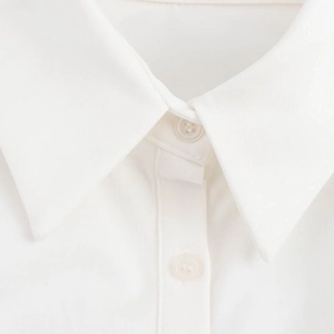 Close-up of a white twill cotton shirt collar with two translucent buttons and sharp texture