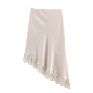 Detailed view of champagne satin midi skirt featuring delicate floral lace trim at the hem