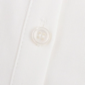 Detail of white resin four-hole button and twill cotton fabric on a short sleeve shirt