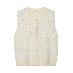 Chic cream knit vest with pearl buttons and sequined bow detailing in a loose fit