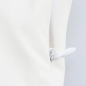 Close-up detail of smooth white invisible zipper on elegant twill fabric dress