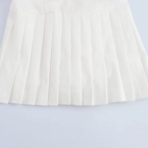 Detailed view of the crisp pleats and woven fabric on this white shirt dress