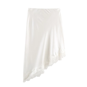Detail of elegant white satin skirt featuring premium lace trim and asymmetric hemline