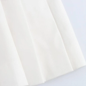 Detailed macro view of white twill pleated fabric texture on a short sleeve dress