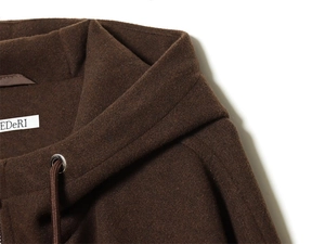 Detail of hooded neckline with woven drawstring and branded label on brown jacket