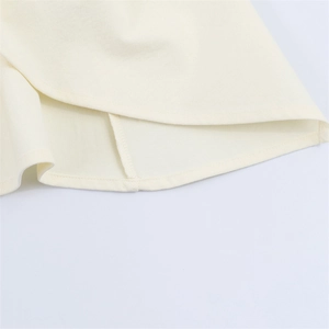 Beige knit halter top featuring premium double-needle flat stitching and hem details