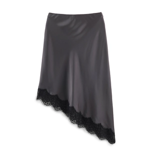 Detail view of grey satin midi skirt with asymmetric black eyelash lace trim hemline