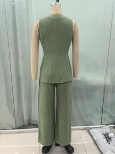 Detail view of sage green two-piece set featuring buttoned vest and wide-leg trousers