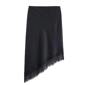 Detail of elegant black satin midi skirt featuring irregular hem and eyelash lace trim