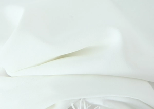 Close-up detail of white chiffon fabric showing soft drape and subtle crinkle texture