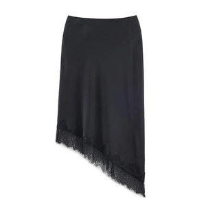 Detailed macro view of elegant black satin skirt hem with delicate floral lace trim