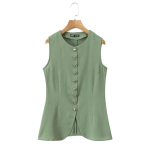 Detail of sage green vest featuring textured fabric and silver conical metal buttons