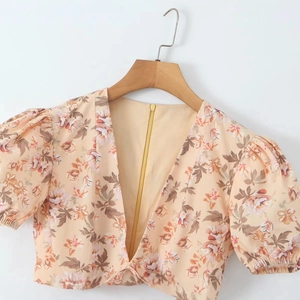 Floral puff sleeve V-neck top in apricot with back zipper and spring summer design