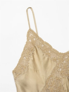 Close-up of champagne satin camisole with exquisite floral lace neckline and thin straps