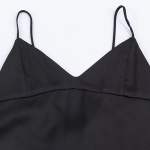 Close-up of black satin camisole top featuring V-neckline and delicate thin straps