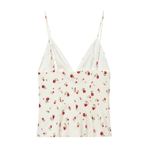 Detail of red rose floral print on white satin camisole with delicate straps