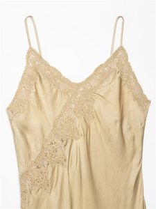 Detailed view of champagne silk camisole featuring delicate lace trim and V-neckline