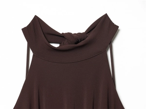 Close-up of dark brown halter neck collar with twisted knot detail on knit dress fabric