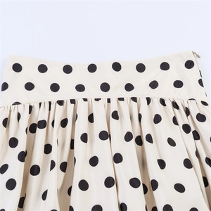Detail of waist design with invisible side zipper and pleats on polka dot skort