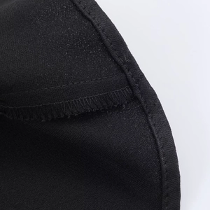 Close-up of the fine edge stitching and silky satin fabric texture on black camisole top