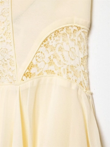 Close-up of cream chiffon dress featuring delicate white floral lace patchwork detailing