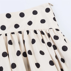 Detail of polka dot skirt with invisible zipper and elegant pleated waist design