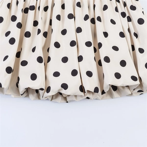 Close-up of stylish black polka dot pattern on beige bubble hem fabric texture
