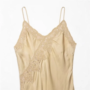 Elegant champagne silk satin camisole with beige lace trim and adjustable thin straps
