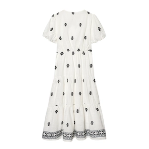 White V-neck dress with black star embroidery, puff sleeves and tiered cake-style skirt
