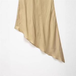 Slim fit champagne satin skirt with asymmetrical hem and elegant silk drape texture