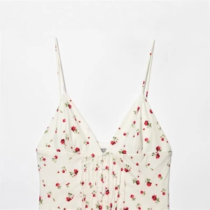 White floral spaghetti strap top with red roses, V-neck pleats and decorative buttons
