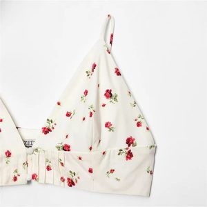 White floral crop top with red roses, thin straps and ruched hem details