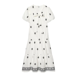 White tiered midi dress with puff sleeves, bow tie V-neck and black floral embroidery