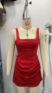 Detail view of red ruched bodycon mini dress with square neck and spaghetti straps