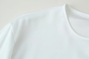 Detail shot of the white lace patchwork long sleeve top showing neckline and stitching