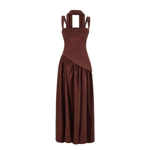 Detail of coffee brown halter dress with asymmetric layered drapes and pleated hem