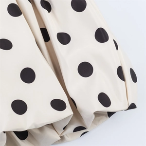 Chic cream mini skort with black polka dots featuring voluminous ruffled puff hem details